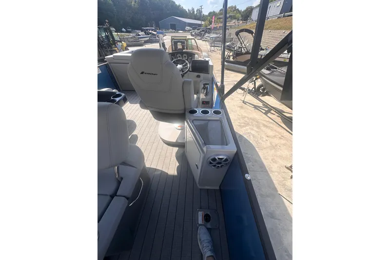 Slide: The Image of 2026 Starcraft CX 23 DL BAR boat interior with seating and control panel. - 6