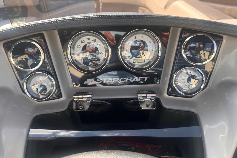 Slide: The Image of Dashboard of 2026 Starcraft CX 23 DL BAR boat with gauges and controls. - 9