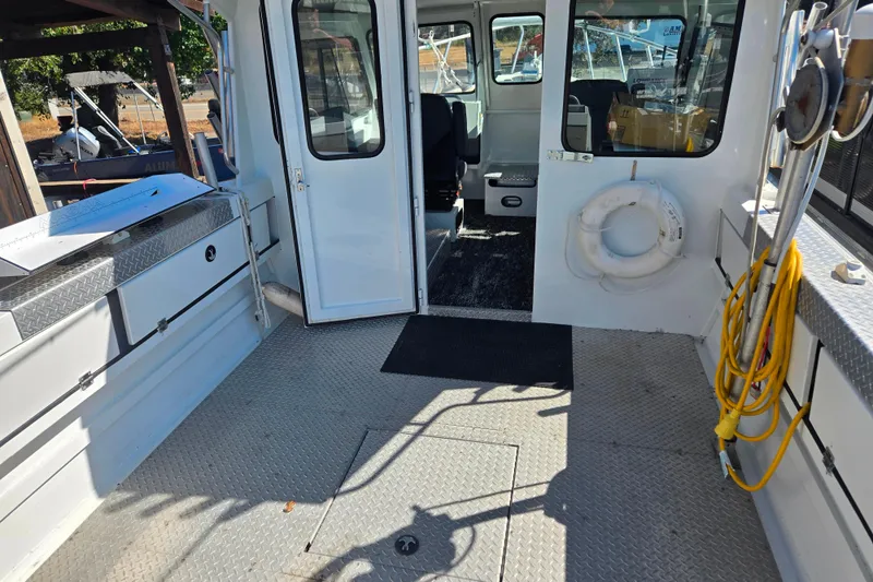 Slide: The Image of 2020 Raider 250 Sea Raider boat interior with open cabin door and safety equipment. - 12
