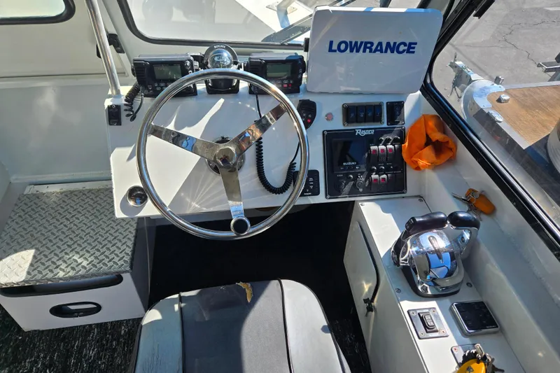 Slide: The Image of 2020 Raider 250 Sea Raider boat cockpit with steering wheel and control panel. - 15