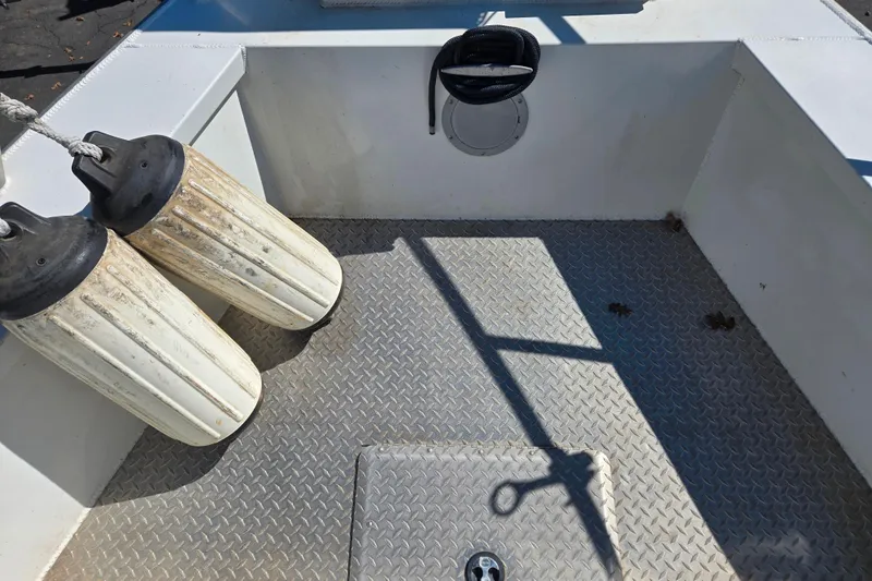 Slide: The Image of 2020 Raider 250 Sea Raider boat deck with fenders and diamond plate flooring. - 18