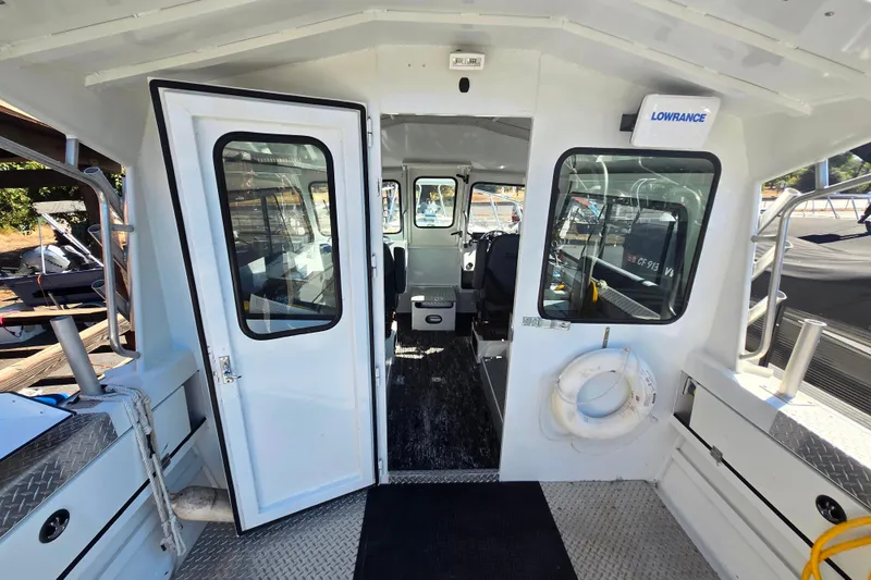 Slide: The Image of 2020 Raider 250 Sea Raider boat interior with open cabin door and life preserver. - 19