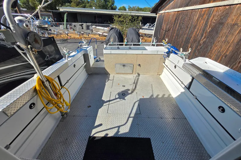 Slide: The Image of 2020 Raider 250 Sea Raider boat interior with fishing equipment and storage compartments. - 21