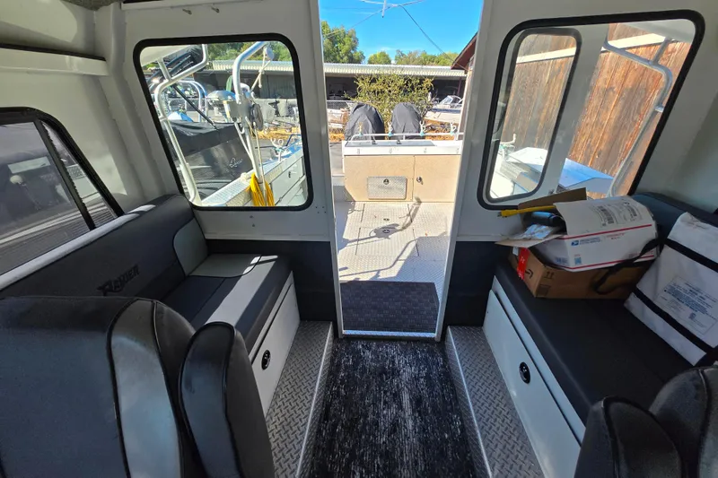 Slide: The Image of Interior of 2020 Raider 250 Sea Raider boat with seating and storage. - 22