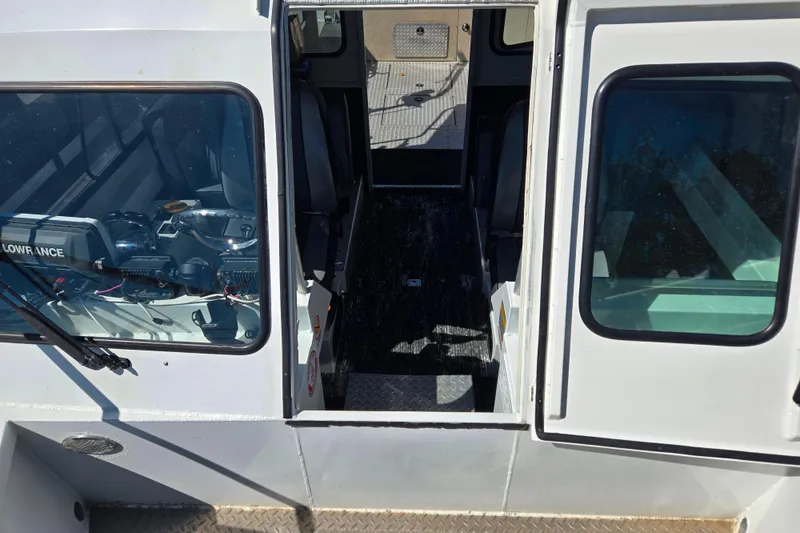 Slide: The Image of 2020 Raider 250 Sea Raider boat interior with navigation equipment and seating. - 28