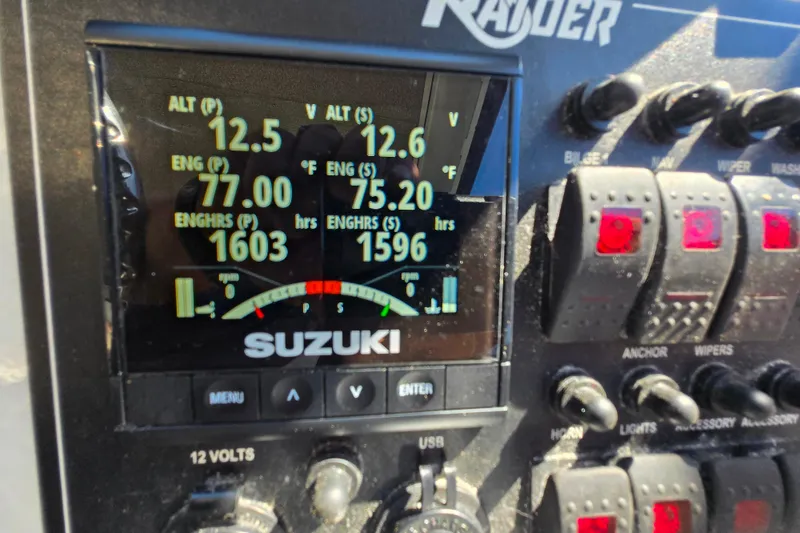Slide: The Image of Control panel of a 2020 Raider 250 Sea Raider boat with Suzuki display. - 6