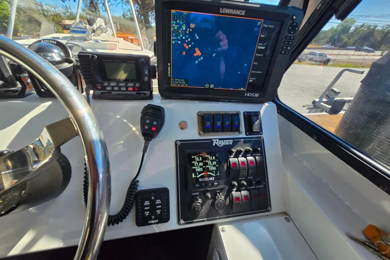 Slide: The Image of 2020 Raider 250 Sea Raider boat dashboard with navigation and control systems. - 7