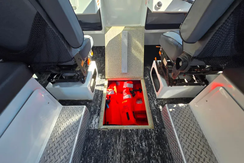 Slide: The Image of Interior of 2020 Raider 250 Sea Raider showing storage compartment with life jackets. - 8