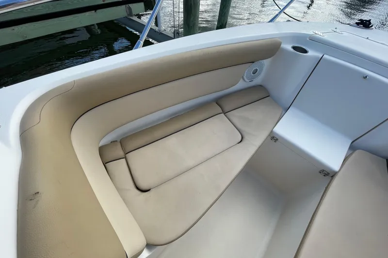 Slide: The Image of Luxurious seating area on a 2015 Scout 245 Dorado boat, featuring beige cushions. - 10