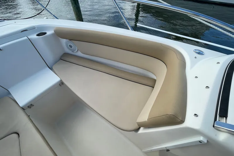 Slide: The Image of 2015 Scout 245 Dorado boat interior with beige seating and speaker. - 11