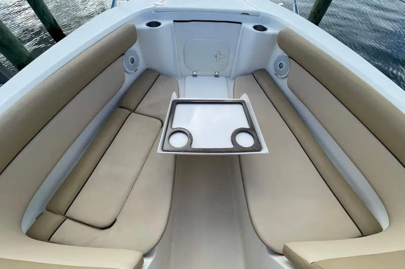 Slide: The Image of 2015 Scout 245 Dorado boat interior with beige seating and a central table. - 12
