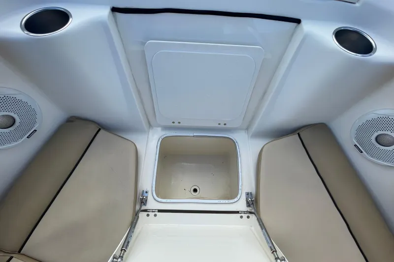 Slide: The Image of Interior of 2015 Scout 245 Dorado boat with storage compartment and speakers. - 15