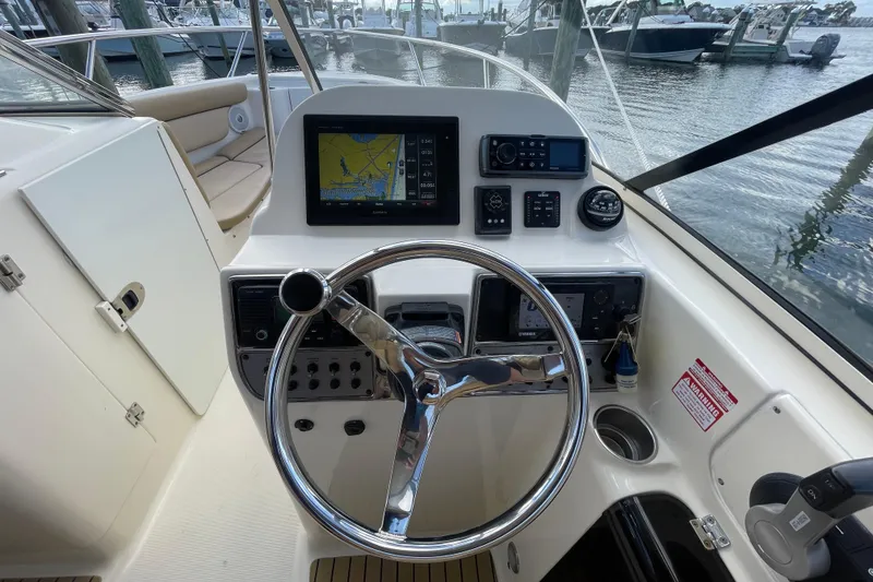 Slide: The Image of 2015 Scout 245 Dorado boat helm with navigation system and steering wheel. - 17