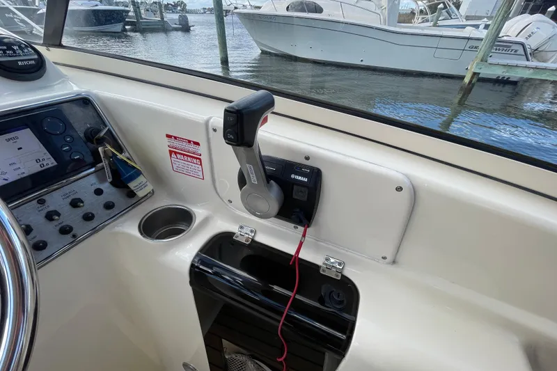 Slide: The Image of 2015 Scout 245 Dorado boat dashboard with Yamaha controls and navigation system. - 19