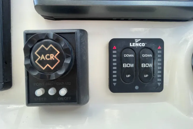 Slide: The Image of Control panel of a 2015 Scout 245 Dorado boat with ACR and Lenco switches. - 24