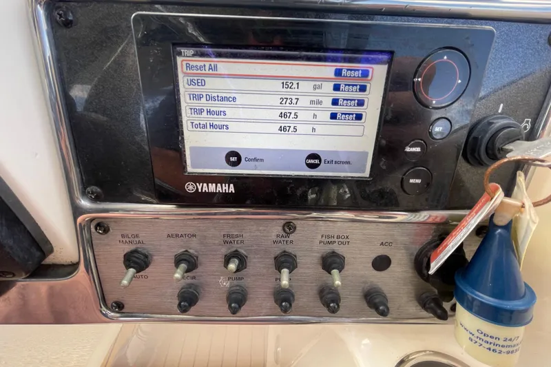 Slide: The Image of Yamaha control panel on 2015 Scout 245 Dorado boat, displaying trip data and switches. - 25
