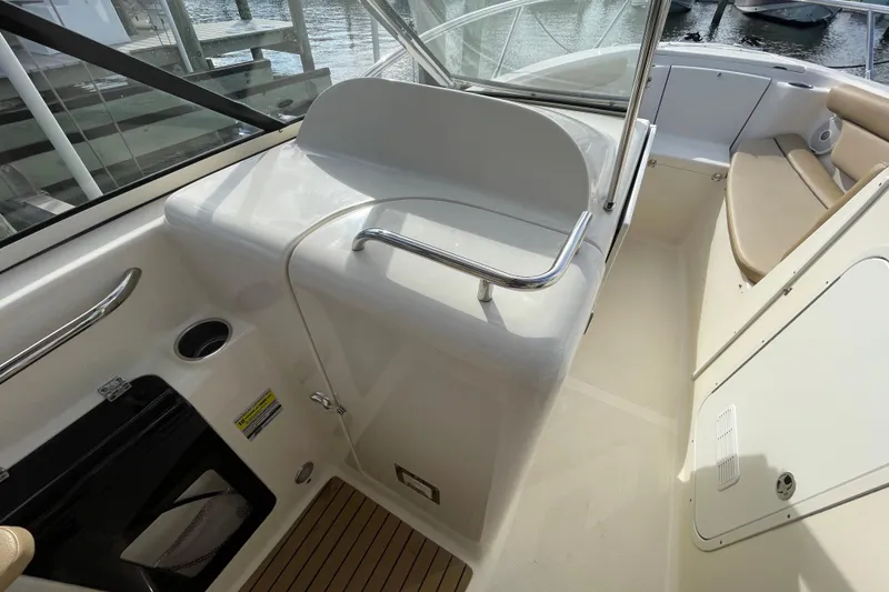 Slide: The Image of 2015 Scout 245 Dorado boat interior with seating and storage compartments. - 27