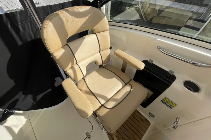 Slide: The Image of Beige captain's chair on 2015 Scout 245 Dorado boat, featuring armrests and sleek design. - 28