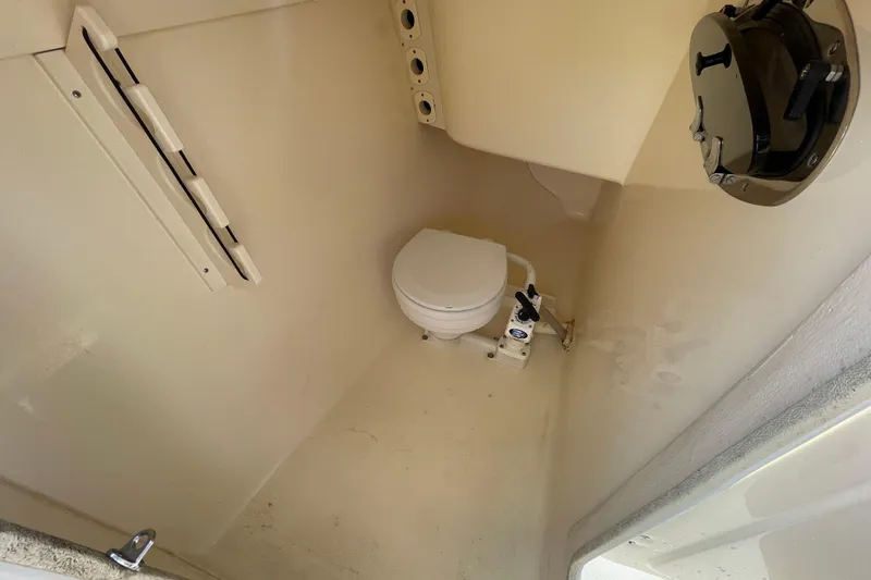 Slide: The Image of 2015 Scout 245 Dorado boat interior with compact marine toilet. - 30