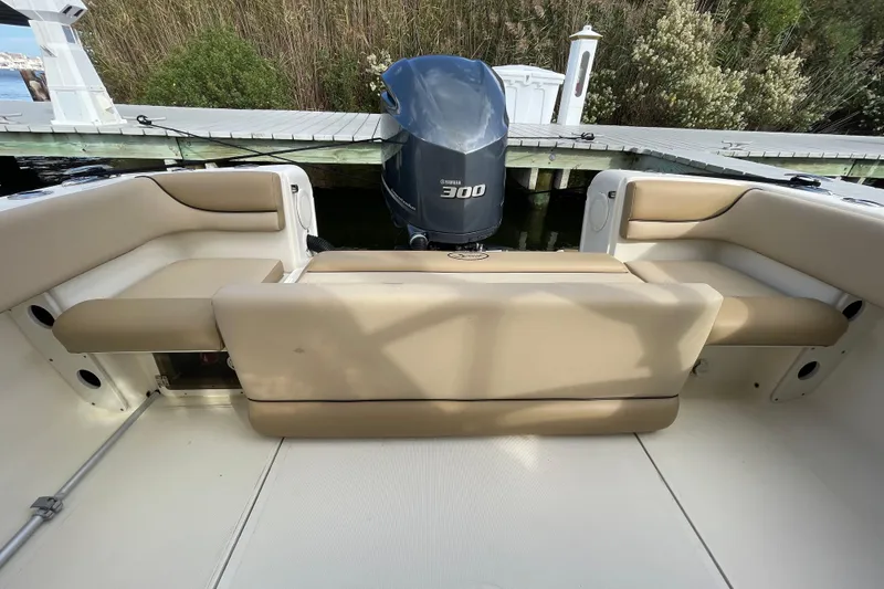 Slide: The Image of 2015 Scout 245 Dorado boat interior with beige seating and Yamaha 300 engine. - 32