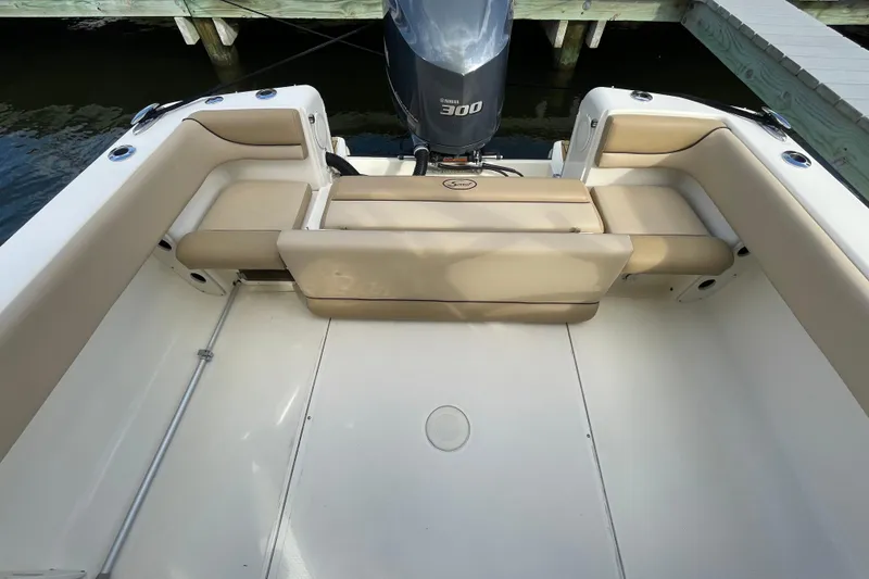 Slide: The Image of 2015 Scout 245 Dorado boat interior with beige seating and Yamaha 300 engine. - 34