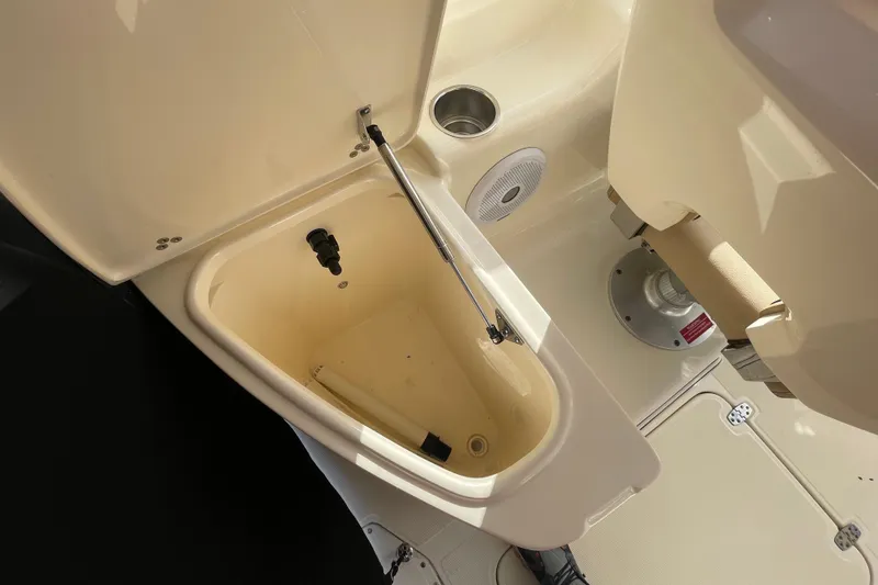 Slide: The Image of Open storage compartment on 2015 Scout 245 Dorado boat, featuring cup holder and speaker. - 36