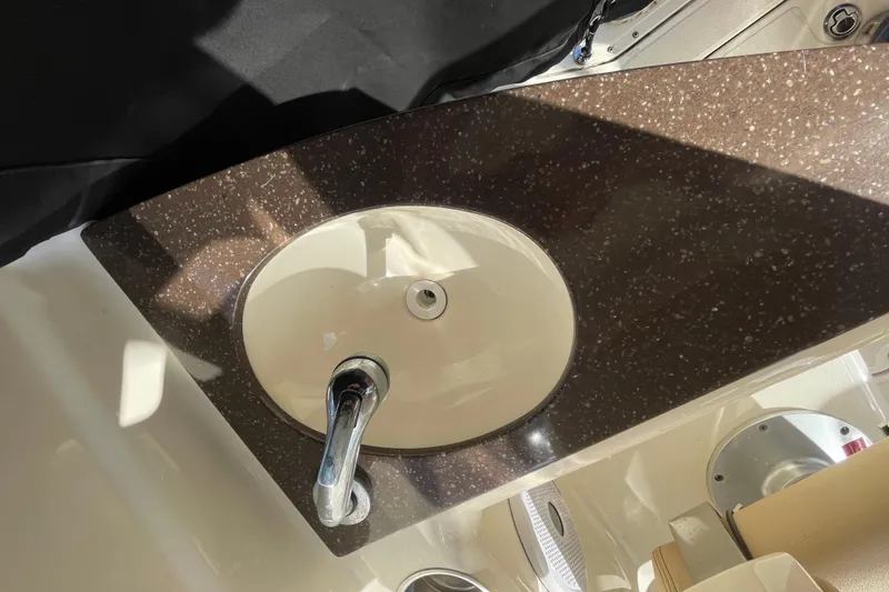 Slide: The Image of 2015 Scout 245 Dorado boat sink with brown countertop and chrome faucet. - 37