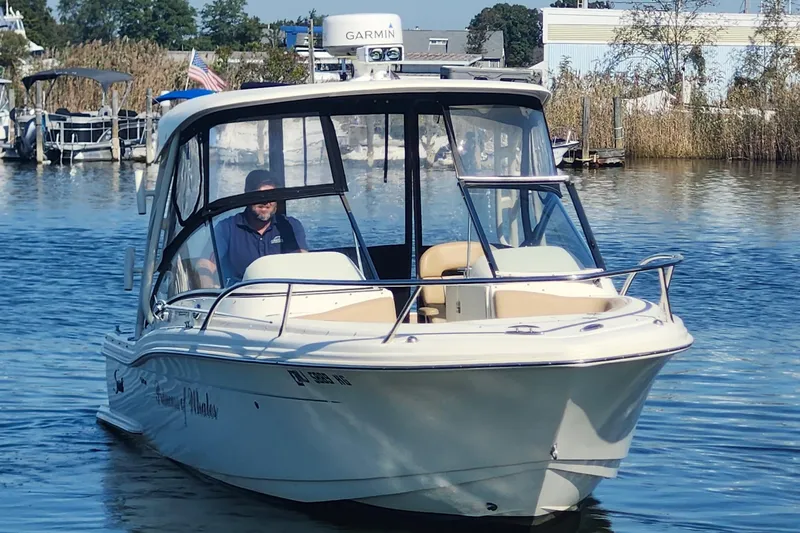 Slide: The Image of 2015 Scout 245 Dorado boat on water, featuring Garmin equipment. - 4