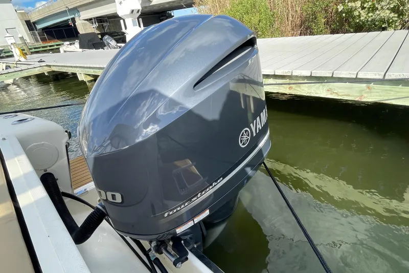 Slide: The Image of Yamaha outboard motor on a 2015 Scout 245 Dorado boat docked by the water. - 40