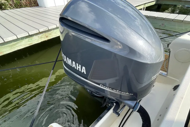 Slide: The Image of Yamaha outboard motor on 2015 Scout 245 Dorado boat docked by wooden pier. - 44