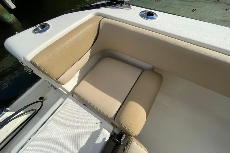 Slide: The Image of 2015 Scout 245 Dorado boat seat with beige upholstery and cup holders. - 46