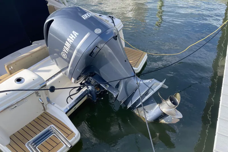 Slide: The Image of 2015 Scout 245 Dorado with Yamaha outboard motor docked in water. - 48
