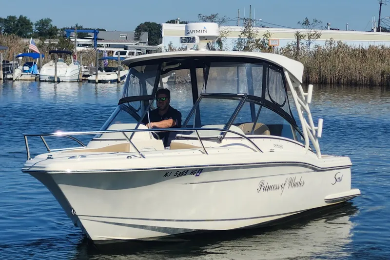 Slide: The Image of 2015 Scout 245 Dorado boat cruising on a calm waterway. - 5