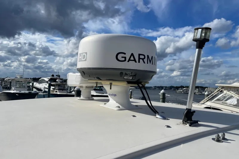 Slide: The Image of Garmin radar on 2015 Scout 245 Dorado boat, docked under cloudy sky. - 50