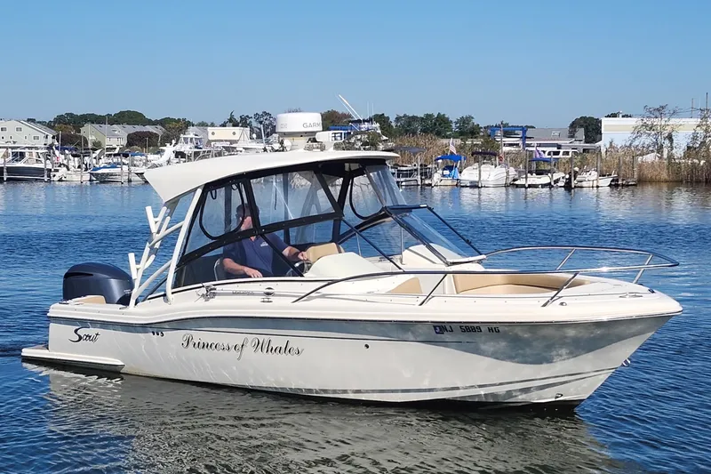 Slide: The Image of 2015 Scout 245 Dorado boat named "Princess of Whales" on calm water. - 6