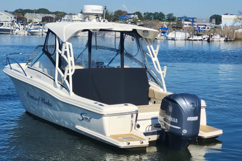 Slide: The Image of 2015 Scout 245 Dorado boat with Yamaha engine docked in a marina. - 7