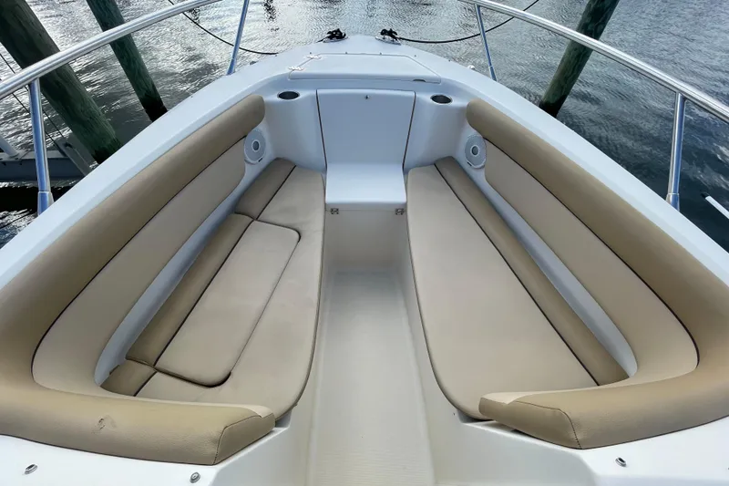 Slide: The Image of 2015 Scout 245 Dorado boat interior with beige seating and cup holders. - 9