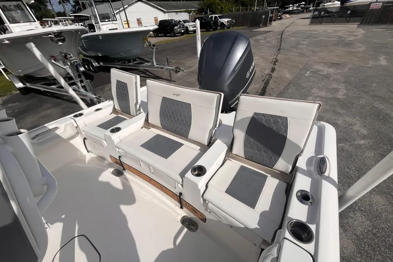 Slide: The Image of 2017 Tidewater 2500 Carolina Bay boat with cushioned seating and Yamaha outboard motor. - 13