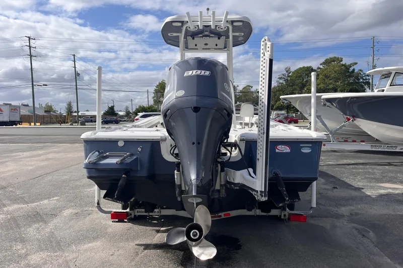 Slide: The Image of 2017 Tidewater 2500 Carolina Bay boat with powerful outboard motor, parked outdoors. - 4