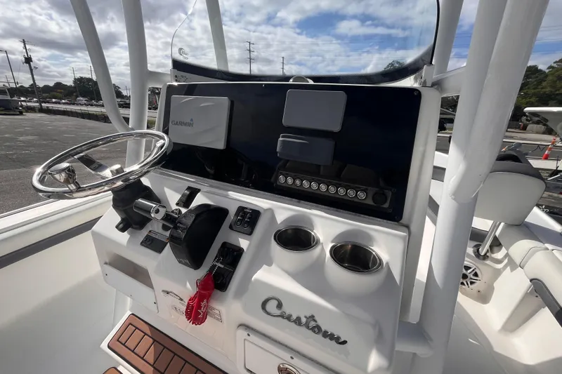 Slide: The Image of 2017 Tidewater 2500 Carolina Bay boat console with Garmin navigation system and steering wheel. - 8