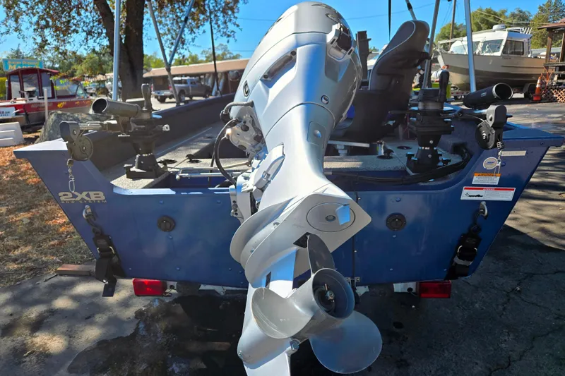 Slide: The Image of 2022 Alumacraft Escape 145 CS boat with motor, docked outdoors. - 4