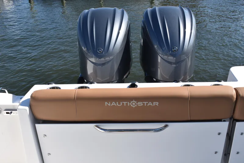 Slide: The Image of 2025 NauticStar 332 Offshore boat with dual engines on water. - 13