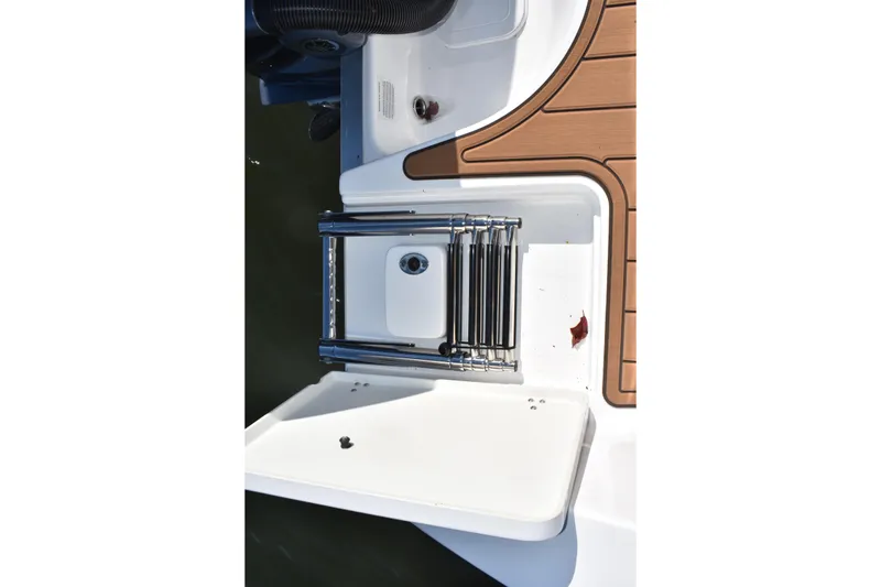 Slide: The Image of 2025 NauticStar 332 Offshore boat ladder and deck detail. - 19