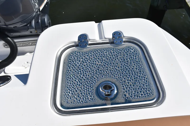 Slide: The Image of Livewell on 2025 NauticStar 332 Offshore boat, featuring a bubbled lid design. - 23