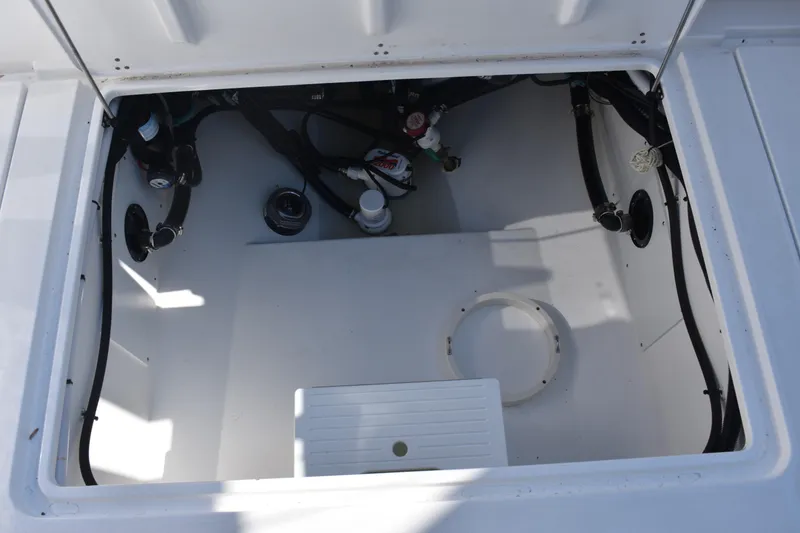 Slide: The Image of Open compartment of 2025 NauticStar 332 Offshore boat, showing internal components and wiring. - 26