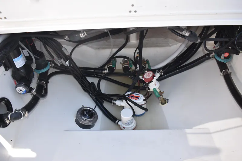 Slide: The Image of Bilge area of 2025 NauticStar 332 Offshore boat, showing pumps and hoses. - 27