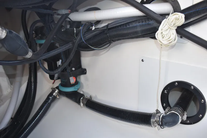 Slide: The Image of Interior view of 2025 NauticStar 332 Offshore boat showing complex wiring and plumbing. - 29