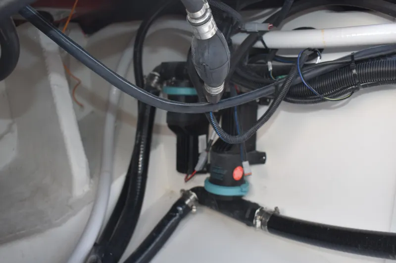 Slide: The Image of 2025 NauticStar 332 Offshore boat wiring and plumbing system close-up. - 30