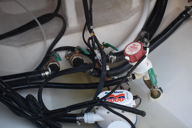 Slide: The Image of Bilge area of 2025 NauticStar 332 Offshore boat with hoses and valves. - 31