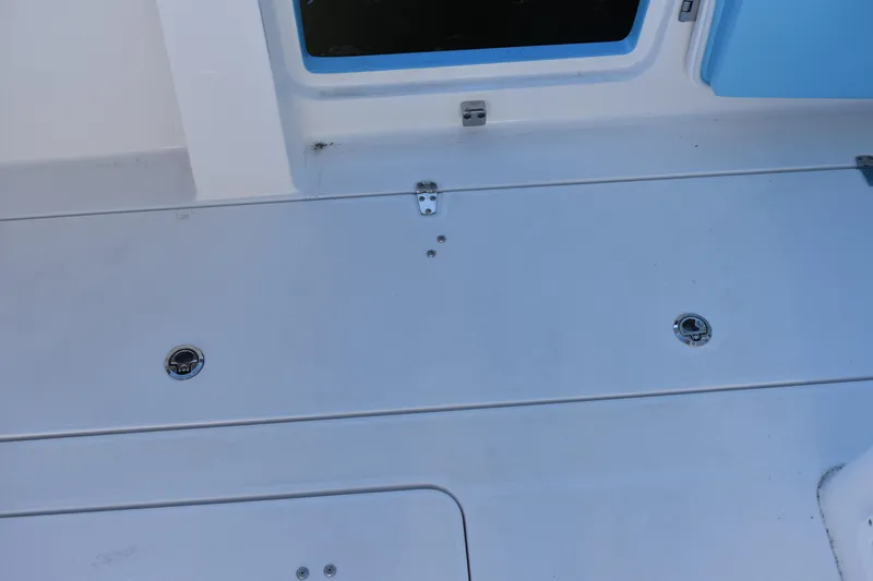 Slide: The Image of 2025 NauticStar 332 Offshore boat deck with storage compartments. - 33